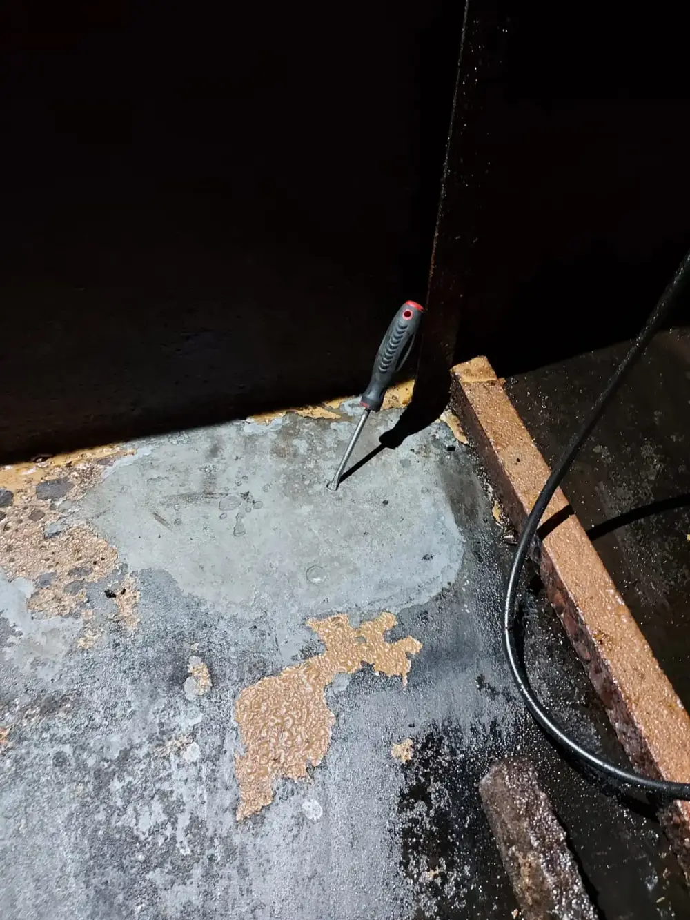 Schraubenzieher steckt in einem Lochfraß-Durchbruch im Tankboden — zeigt die Größe des Lochs